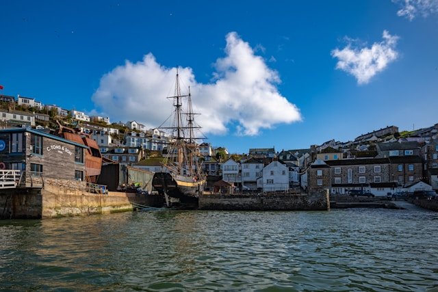 An image of a tall ship in a harbour in Cornwall